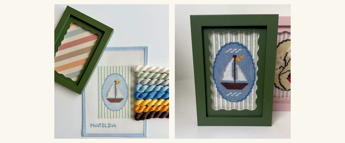 Sailboat needlepoint kit with its green frame beside the same design stitched and framed on a shelf